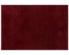 Elegant cherry red wool rug with soft texture and rich color depth.