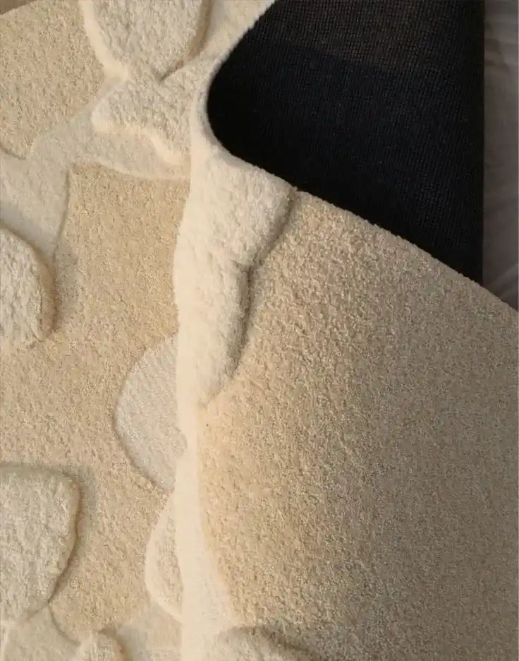 Modern neutral abstract rug with organic irregular cream shapes on textured surface