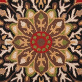Close-up of a modern hand-tufted rug with intricate floral and geometric patterns in brown, green, red, and cream colors