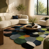 Modern living room with a colorful geometric rug, beige sectional sofa, and armchair.