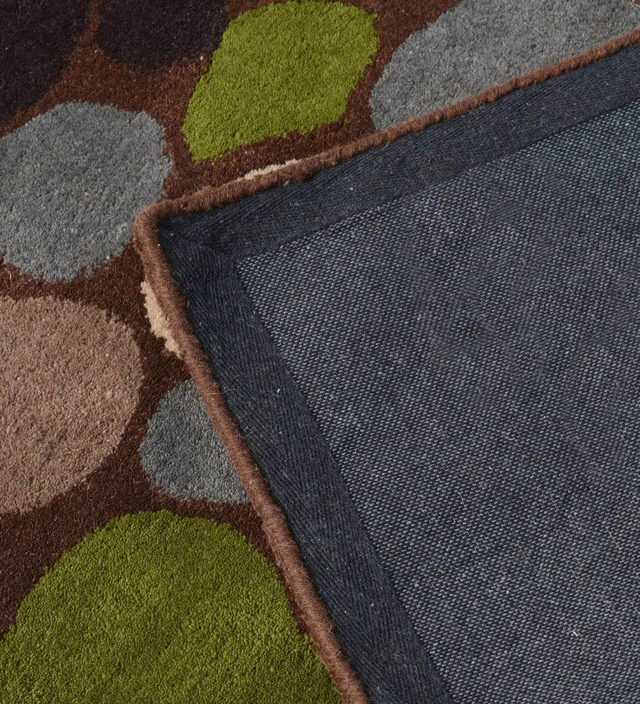 Handcrafted wool rug with playful pebble motif in green and blue