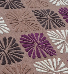 Close-up of a multicolor wool rug with raised floral block patterns in purple, brown, white, and dark tones