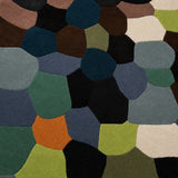 Multicolored geometric patterned rug with various shapes and colors.