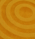 Mustard yellow modern circle design rug with textured concentric rings pattern
