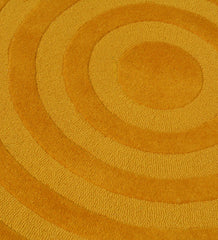Luxury yellow hand-tufted rug with textured circle pattern