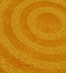 Mustard yellow modern circle design rug with textured concentric rings pattern