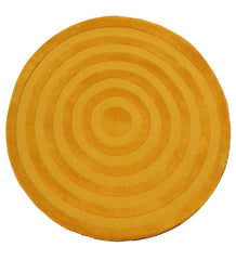 Round mustard yellow rug with concentric circle pattern and textured design