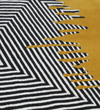 Modern abstract hand-tufted rug for living rooms in mustard, black, and white.