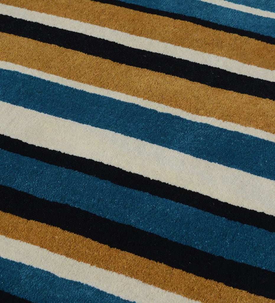 Modern hand-tufted area rug with bold multi-color vertical stripe design.