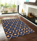 Navy blue modern geometric pattern area rug on dark hardwood floor by fireplace