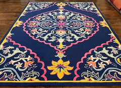Luxury navy blue handwoven rug with intricate floral and geometric patterns in pink, yellow, and white