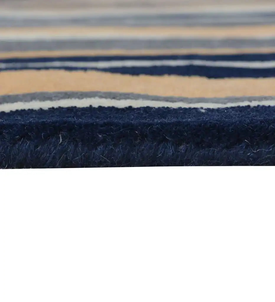 Soft wool hand-tufted rug with vertical pattern in navy, gray and peach hues.