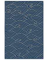 Navy blue and ivory hand-tufted nautical rug with ocean wave pattern.