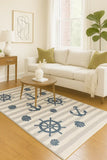 Coastal-inspired nautical rug with seashell and anchor patterns.