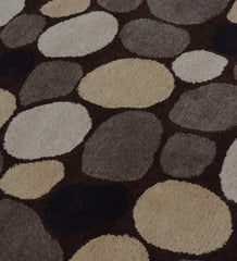 Wool rug with neutral pebble pattern in beige, brown, gray, and black tones