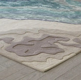 Opulence Thread hand-tufted rug with abstract wavy patterns in blue, beige, and brown on wooden floor