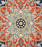 Close-up of a traditional hand-tufted rug with a floral medallion in orange, blue, beige, and white colors
