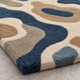 Close-up of navy blue and taupe organic geometric pattern on wool rug for a bedroom, 6x9 size