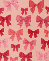 Premium wool pink Christmas rug featuring festive bow motifs.