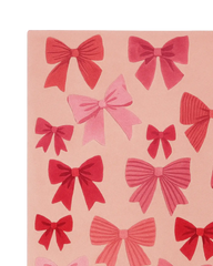Hand-tufted pink holiday rug with sculpted bow details