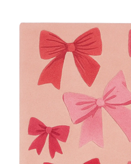 Elegant pink Christmas area rug with assorted bow accents.