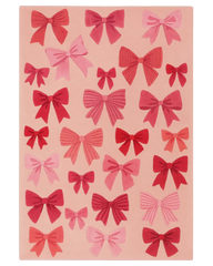 Pink Christmas rug with hand-tufted bow pattern design.