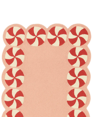 Premium wool pink Christmas rug with red and cream candy motifs.