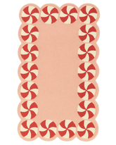 Hand-tufted pink Christmas rug with red peppermint border.