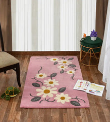 Playful pink rug featuring daisy flowers and green leaves