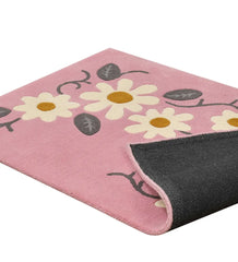 Handcrafted pink rug with cream daisies and vine details