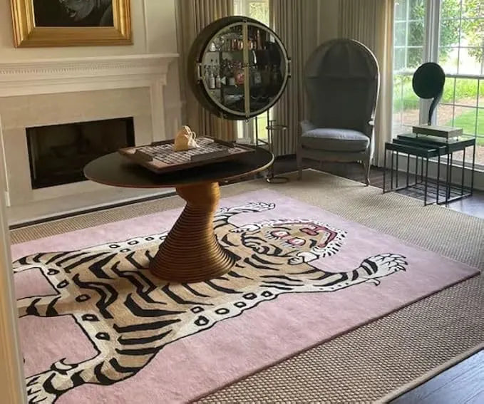 Living room with a tiger-patterned rug, round wooden table, and modern chair.