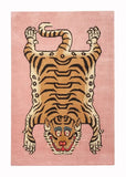 Pink handwoven rug with a modern stylized tiger motif, featuring bold stripes and blue eye accents
