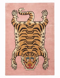 Pink handwoven rug with a modern stylized tiger motif, featuring bold stripes and blue eye accents