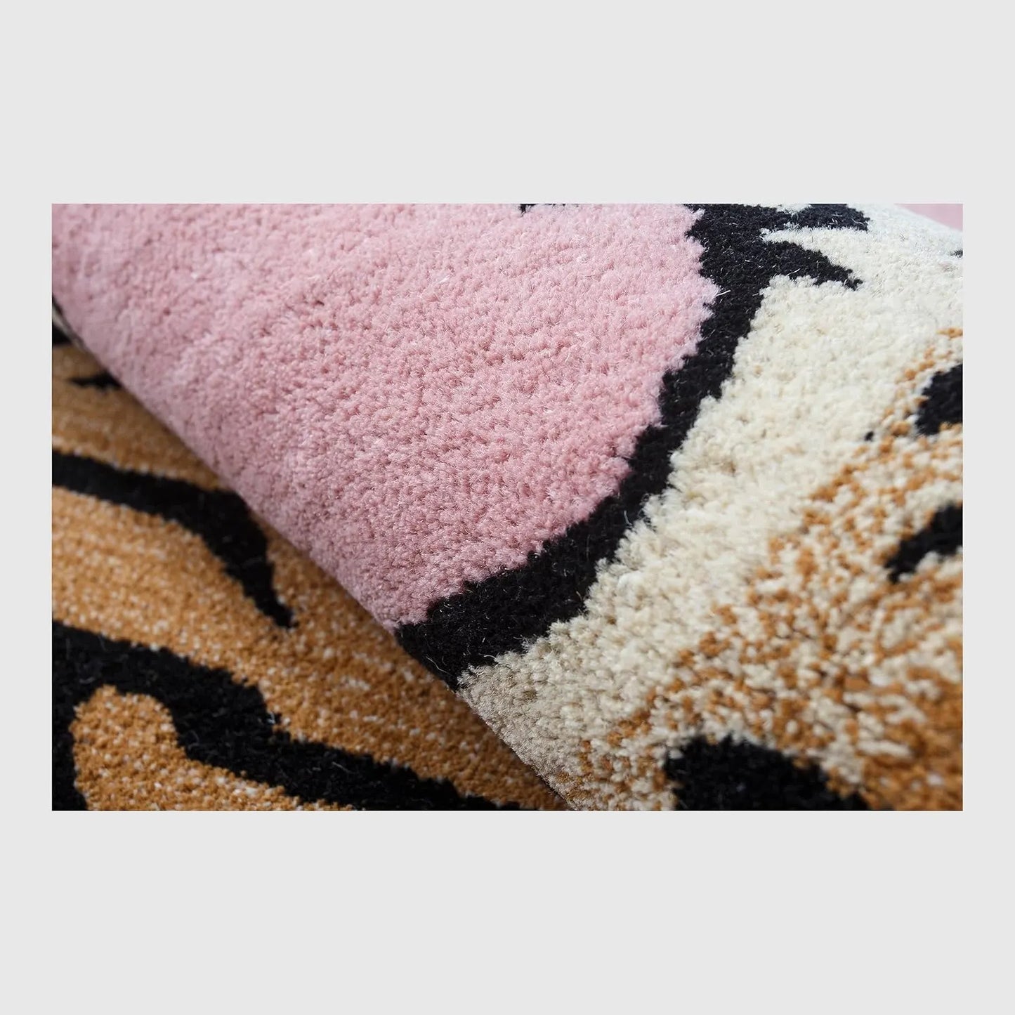 Close-up of a textured pink and multicolored fabric roll on a white background