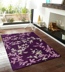 Purple floral vine area rug on wooden floor in modern living room with fireplace and large window