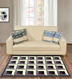 Modern beige sofa with patterned blue and black cushions on a geometric purple, black, gray, and white wool rug in a bright living room