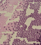 Close-up of modern textured rug with purple and lavender abstract pattern on cream background