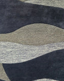 Hand tufted plum purple wave rug with beige accents for bedroom, dining room, or living space.