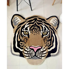 Hand-tufted wool rug shaped like a realistic tiger face with black, beige, white, and pink accents on tiled floor