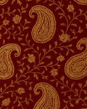 Traditional paisley patterned wool rug in rich red and gold tones.