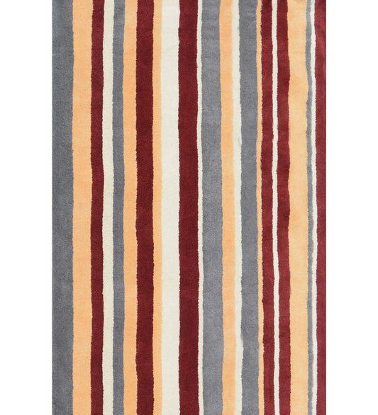 Rust red, mustard, and gray hand-tufted wool rug with modern vertical stripes.