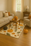 Cozy living room with beige sofa and armchair, autumn-themed pumpkin and mushroom rug, and pumpkins on wooden table