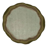 Round handwoven rug with sage green and earthy brown tones, organic layered design