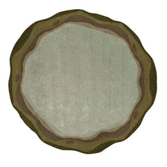 Round handwoven rug with sage green and earthy brown tones, organic layered design