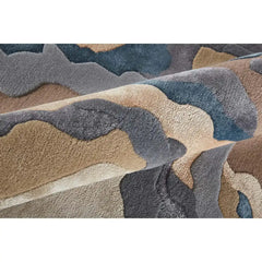 Close-up of Seraphic Bloom hand-tufted rug with abstract organic patterns in muted blue, gray, beige tones