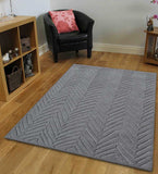 Modern grey rug featuring embossed chevron-inspired design
