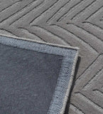 Minimalist grey hand-tufted rug with chevron linear motif