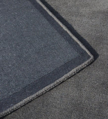 Handcrafted grey rug with embossed rectangle minimalist style