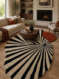 Living room with a black and white striped rug, sofa, coffee table, and fireplace.