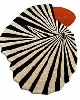 Round rug with black and white striped pattern and a red circular design on a white background